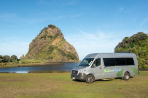 Mercedes bus at Piha Beach on tour